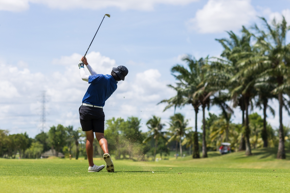 golfer practising his backswing